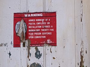 Warning sign on the post office at Valona